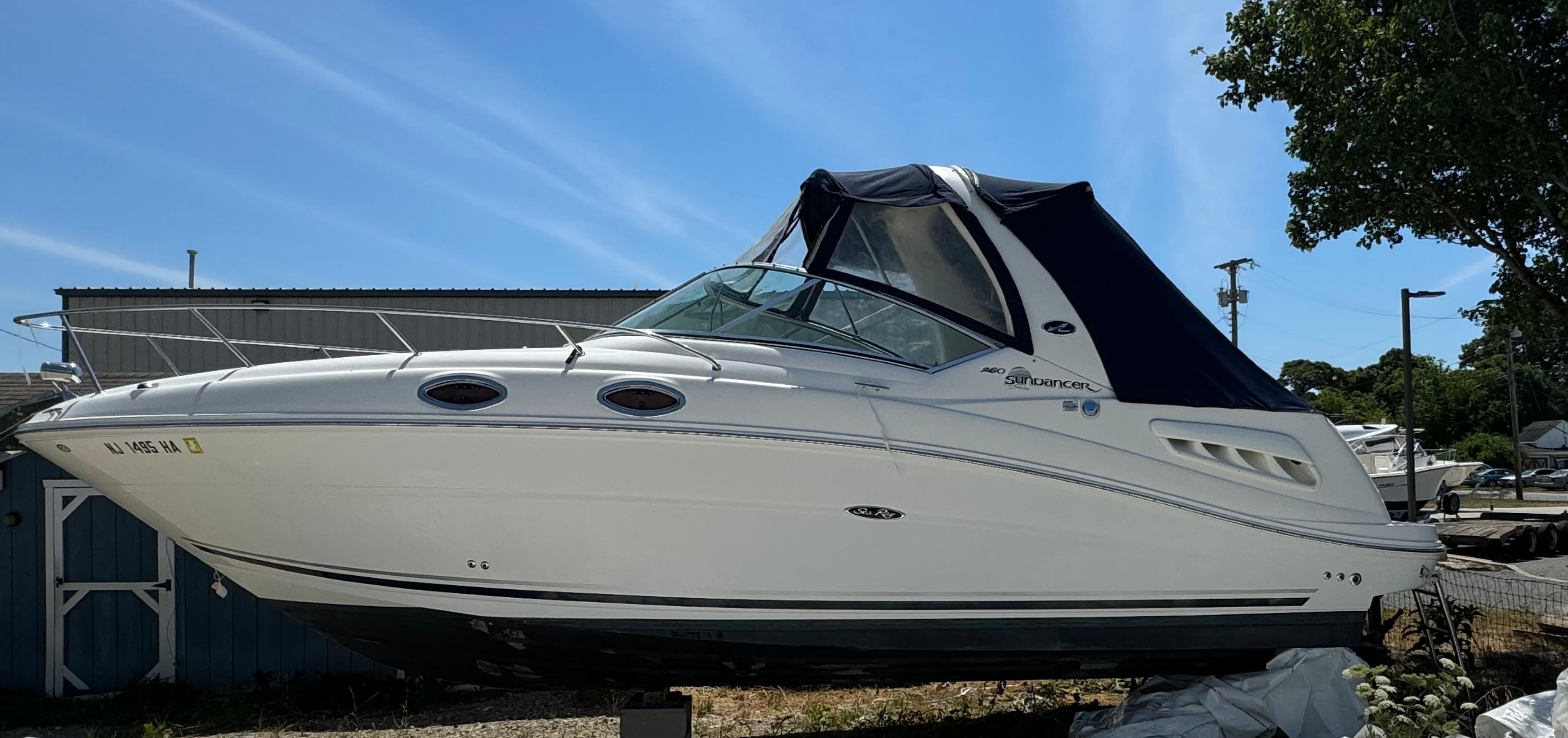 Sea Ray 260 Sundancer 2007 Sea Ray 260 Sundancer boat on land with blue canopy.