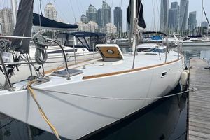 Chaser 39 1982 Chaser 39 sailboat docked in marina with city skyline background.