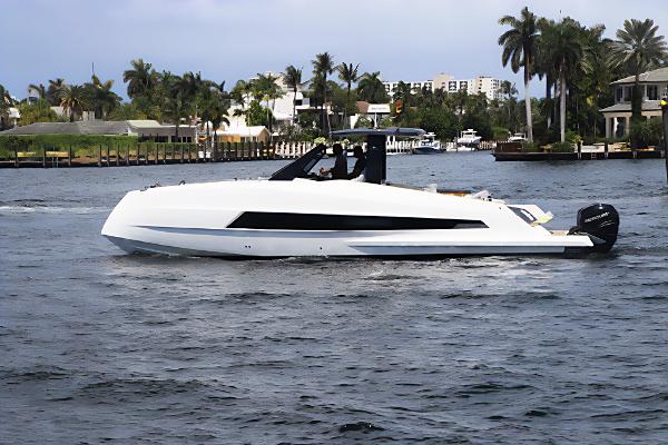 Astondoa 377 Coupe Outboard 2023 Astondoa 377 Coupe Outboard cruising on a scenic waterway with palm trees.