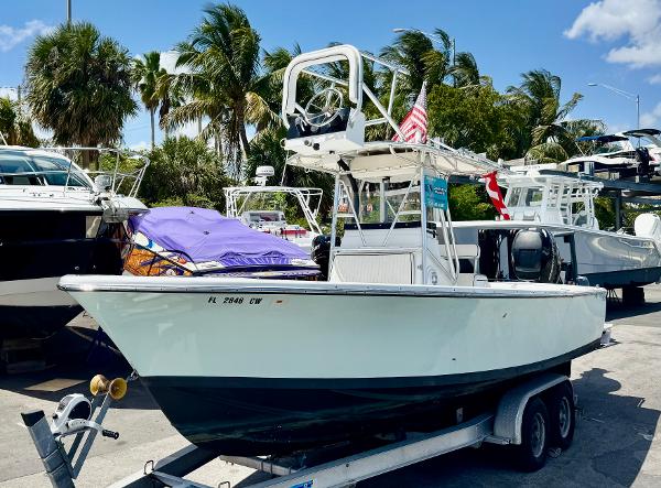 Bertram 25 Mark two convertible sport cruiser 1963 Bertram 25 Mark II sport cruiser on trailer, surrounded by palm trees and other boats.