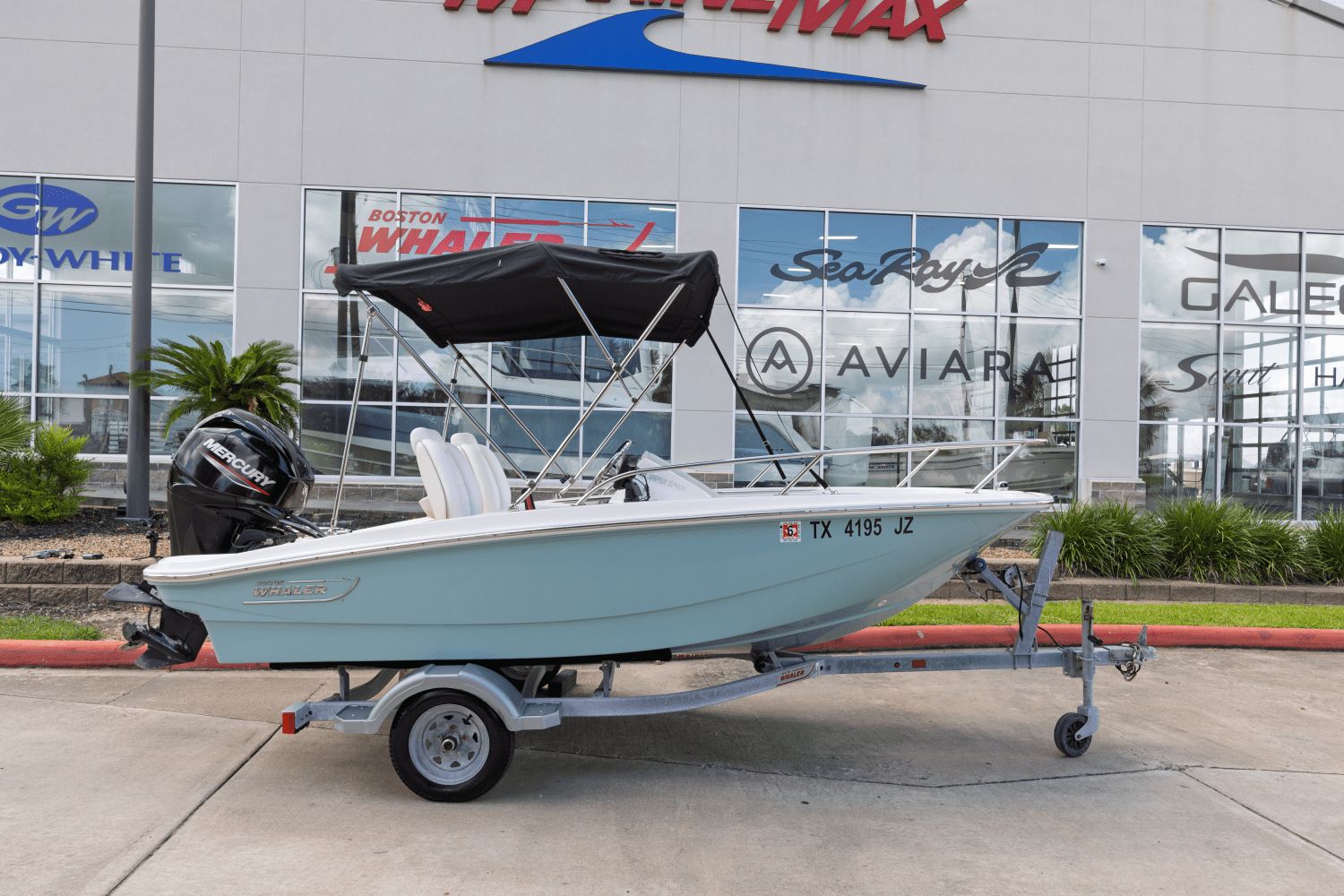 Boston Whaler 130 Super Sport 2021 Boston Whaler 130 Super Sport boat on trailer outside dealership.
