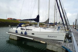 Jeanneau Sun Odyssey 32i 2009 Jeanneau Sun Odyssey 32i sailboat docked, named "Balance," with blue fenders and covered sails.