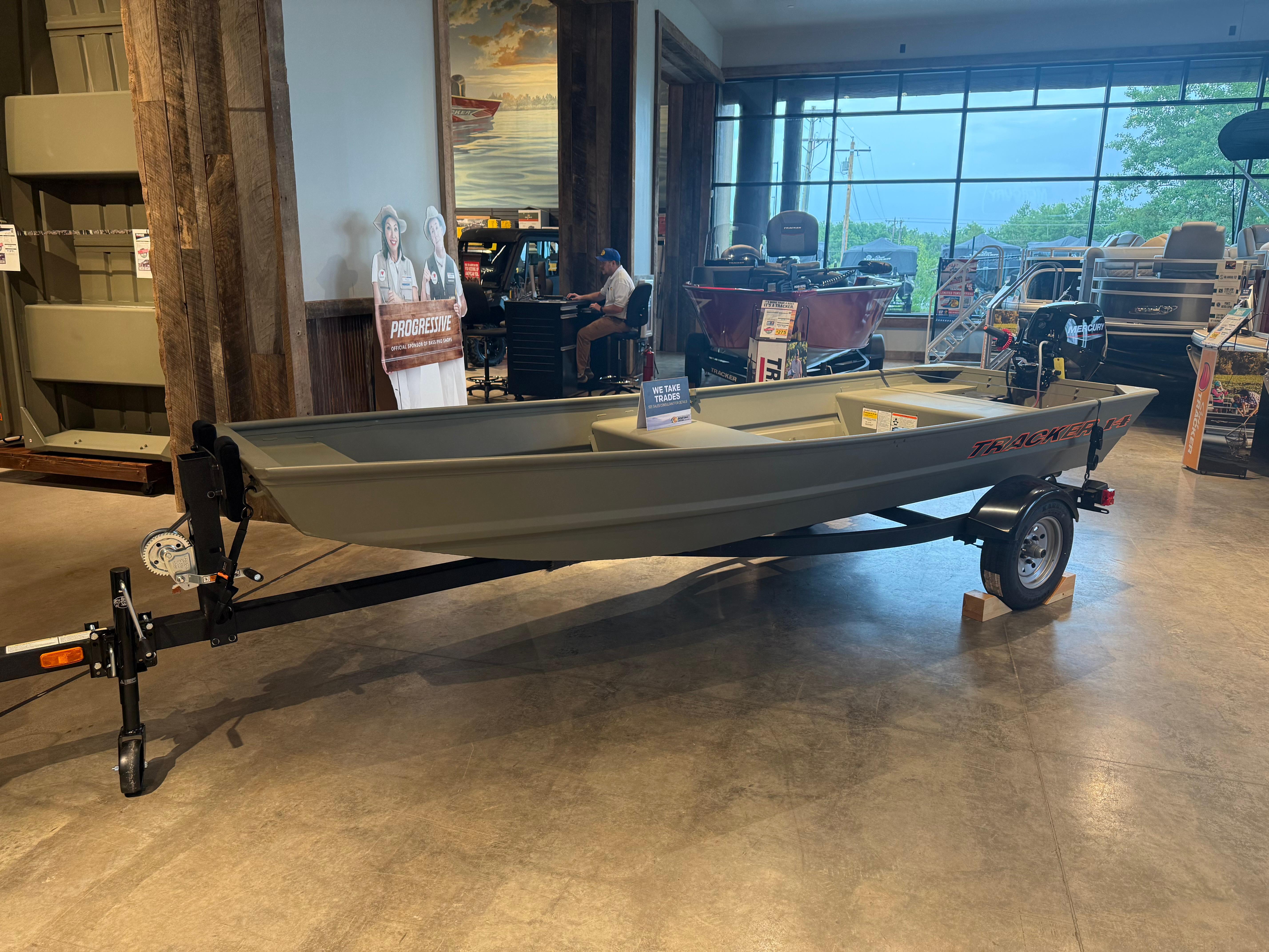 Tracker Grizzly 14 Jon 2025 Tracker Grizzly 14 Jon boat displayed indoors on a trailer.