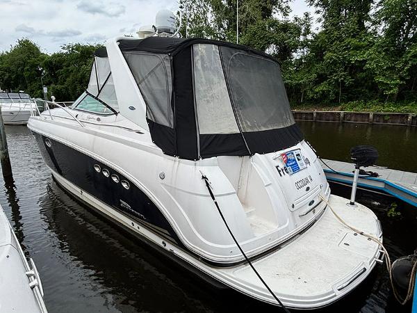 Chaparral 350 Signature 2004 Chaparral 350 Signature boat docked, featuring sleek design and black canopy.