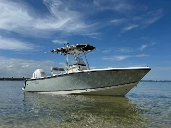 Mako 214C 2019 Mako 214C boat on calm water under a clear blue sky.