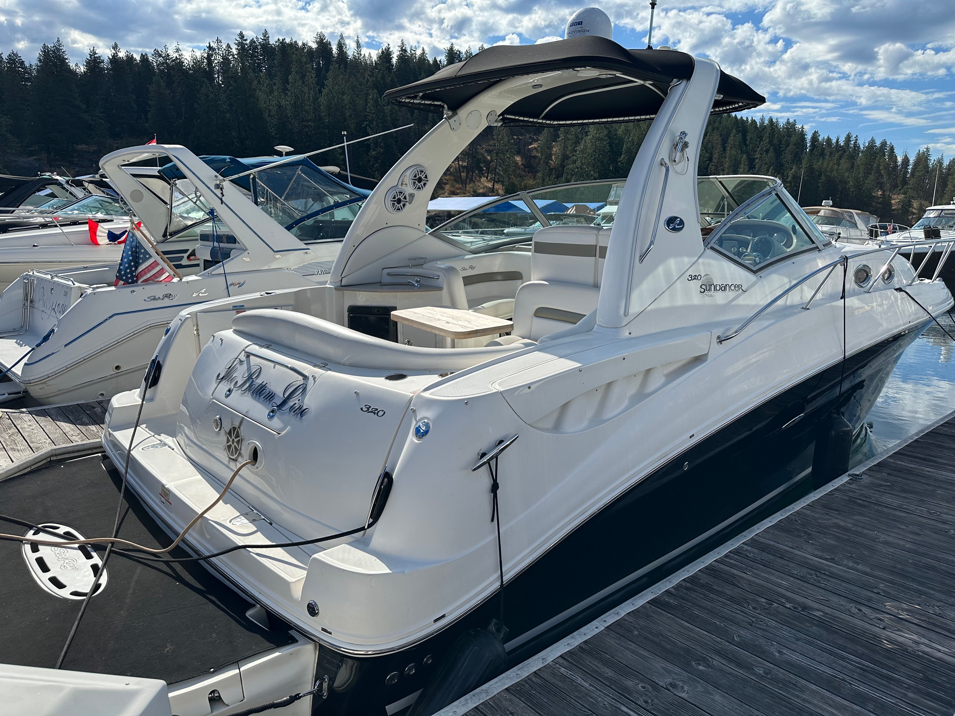 Sea Ray 320 Sundancer 2006 Sea Ray 320 Sundancer docked at marina, surrounded by other boats.