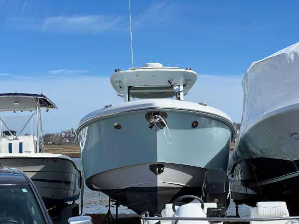 Everglades 325 Center Console 2014 Everglades 325 Center Console boat docked between other vessels.