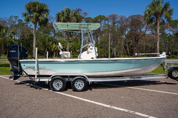 Pathfinder 2400 TRS 2018 Pathfinder 2400 TRS boat on trailer, parked outdoors with palm trees in background.