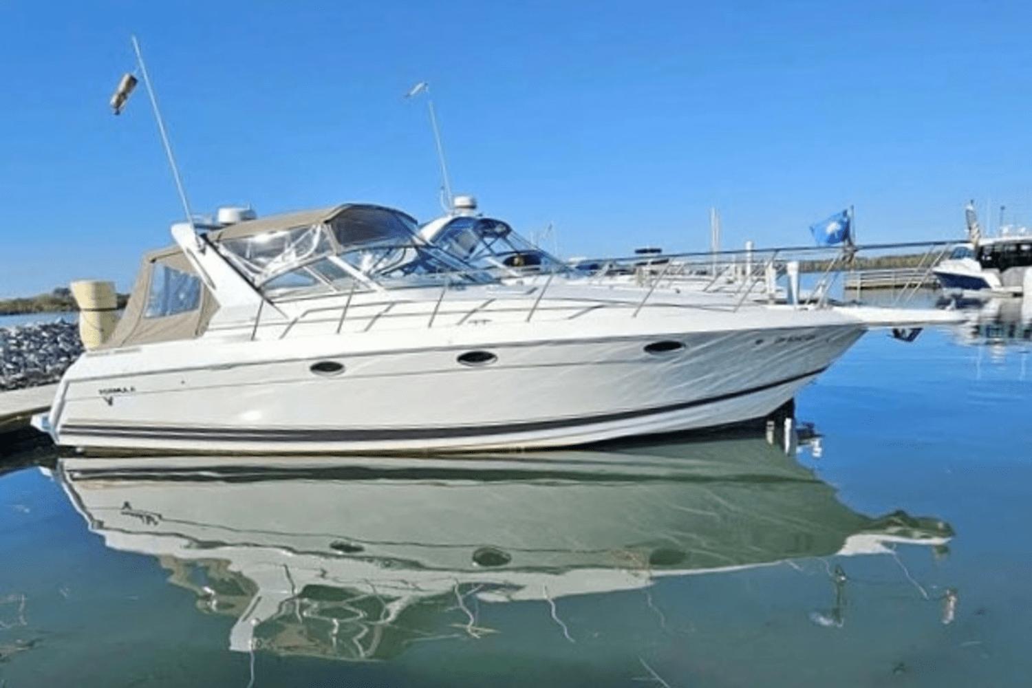 Formula 34 PC 2001 Formula 34 PC yacht docked on calm water under clear blue sky.