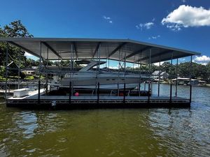Regal Commodore 4260 2004 Regal Commodore 4260 yacht docked under a covered marina on a sunny day.