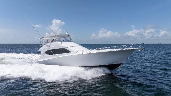 Hatteras GT70 2024 Hatteras GT70 yacht cruising on open water under clear skies.