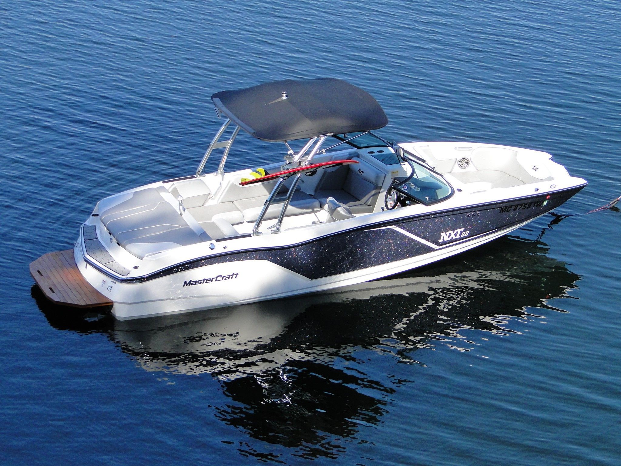 MasterCraft NXT22 2017 MasterCraft NXT22 boat on calm water, featuring sleek design and spacious seating.