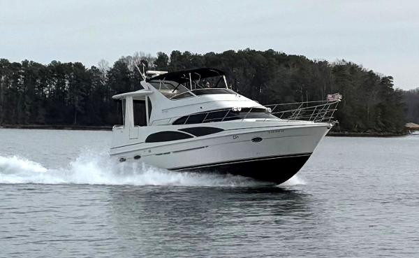 Carver 39 Motor Yacht 2005 Carver 39 Motor Yacht cruising on a lake with forested shoreline.