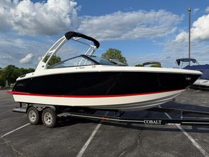 Cobalt R6 2025 Cobalt R6 boat on trailer, black and white design, parked outdoors under cloudy sky.