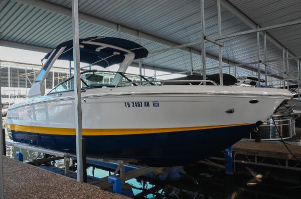 Chaparral 26 Surf 2022 Chaparral 26 Surf boat docked in a marina, featuring a sleek design.