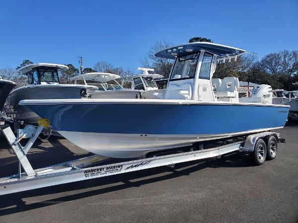 Sportsman Masters 267OE Bay Boat 2024 Sportsman Masters 267OE Bay boat on a trailer in a marina.