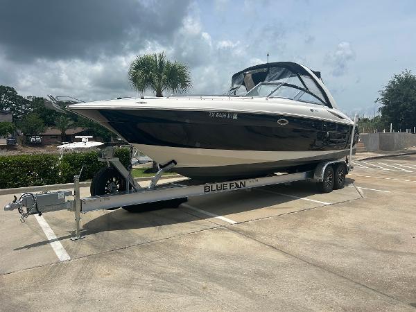 Monterey 298SS Bowrider 2004 Monterey 298SS Bowrider on trailer in parking lot, cloudy sky background.