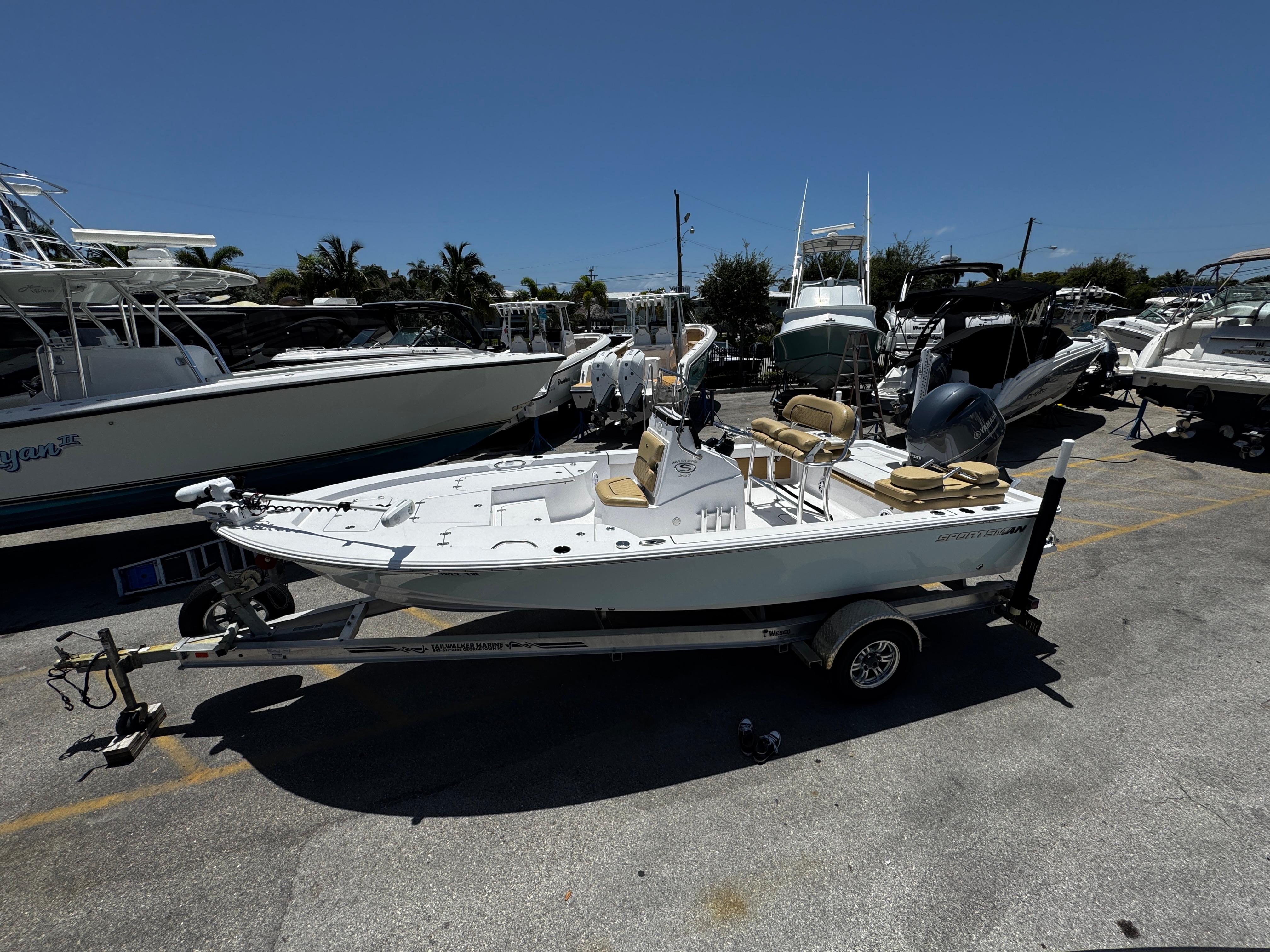 Sportsman Masters 207 Bay Boat 2021 Sportsman Masters 207 Bay Boat on trailer in marina parking lot.