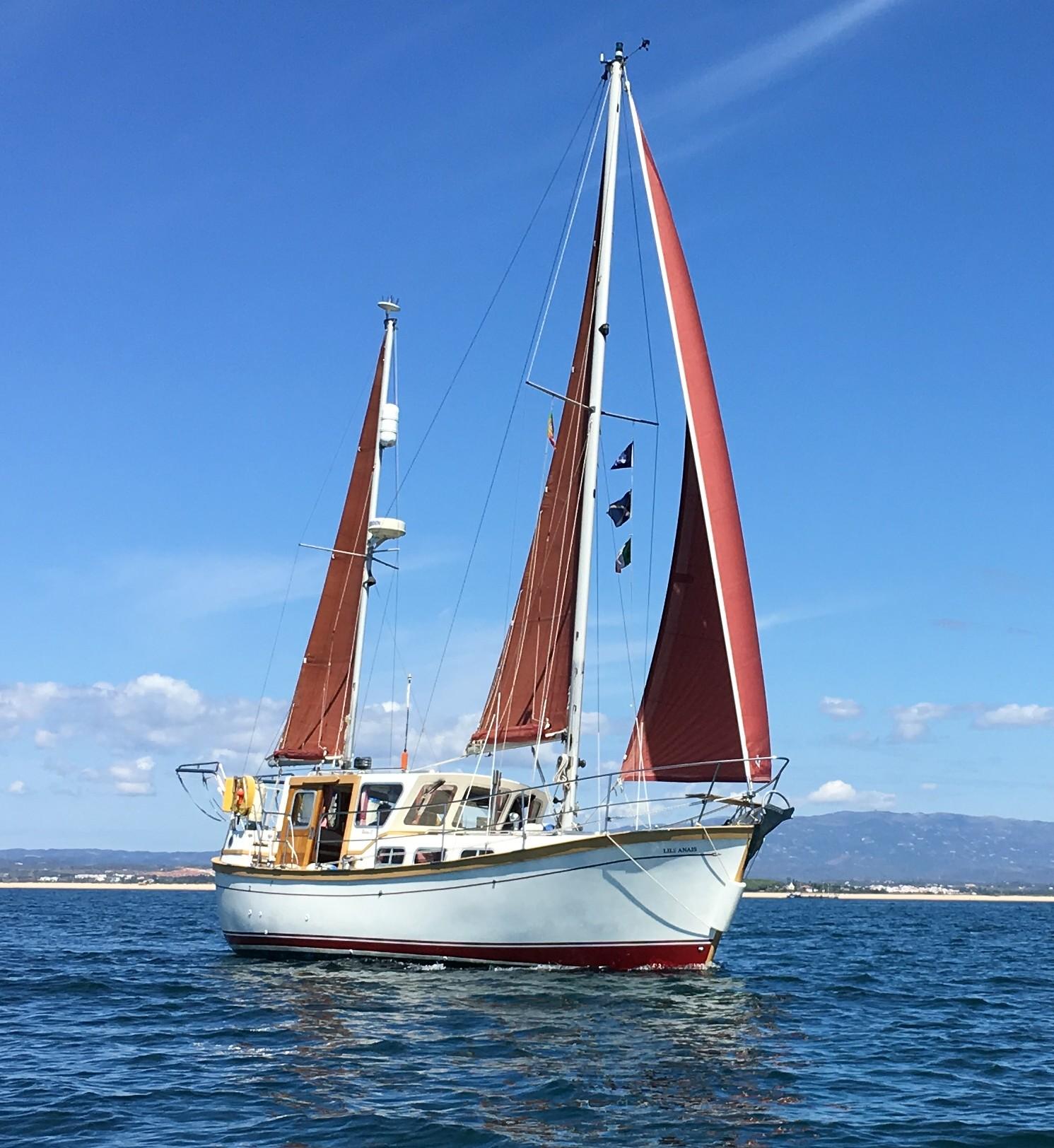 Colvic Watson 32 Sailing yacht Colvic Watson 32, 1994 model, with red sails on open water.