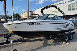 Chaparral 21 SSi 2022 Chaparral 21 SSi boat on trailer, parked outside a Chaparral dealership.