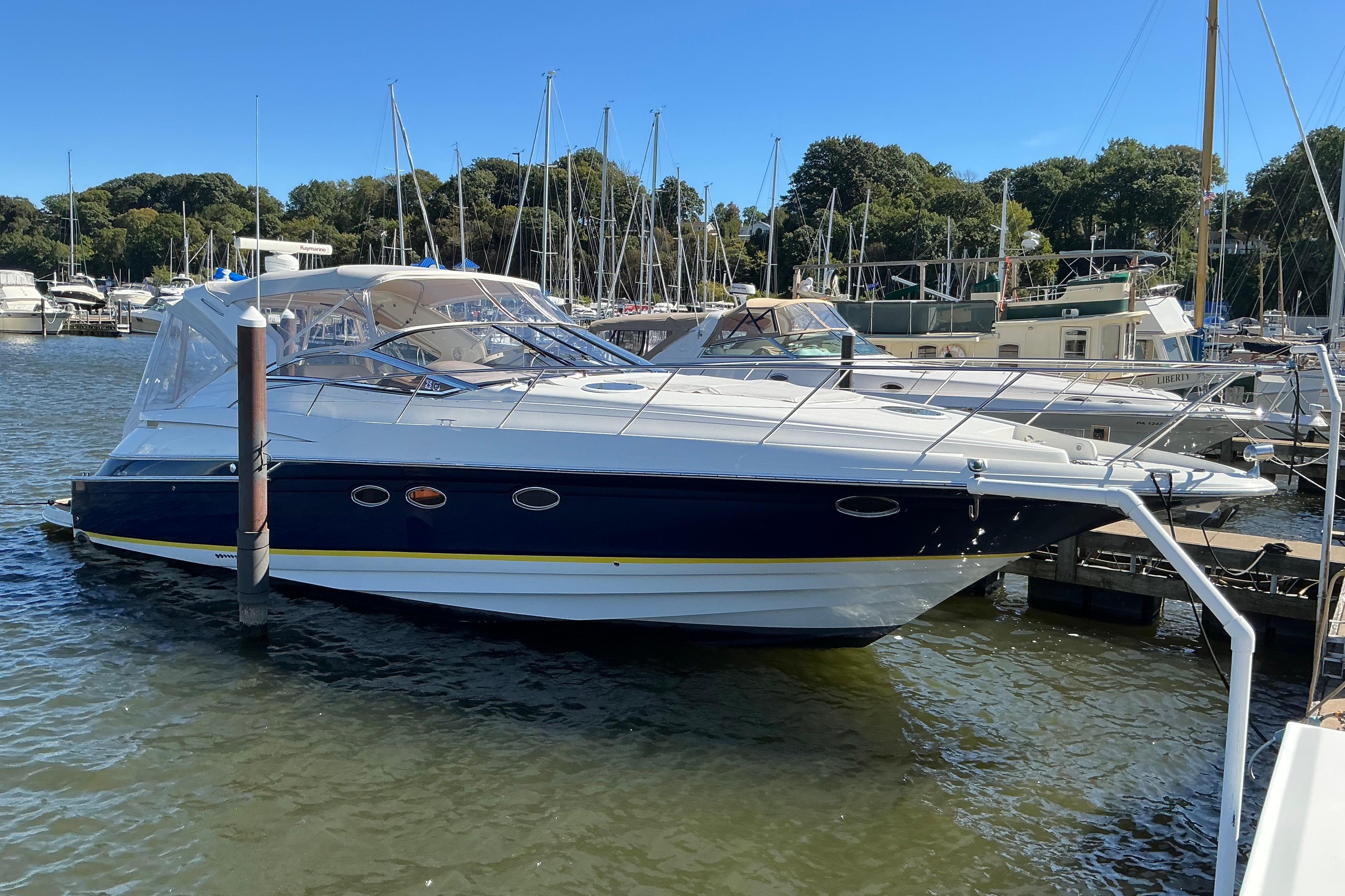 Regal Commodore 4260 2003 Regal Commodore 4260 yacht docked at marina under clear blue sky.