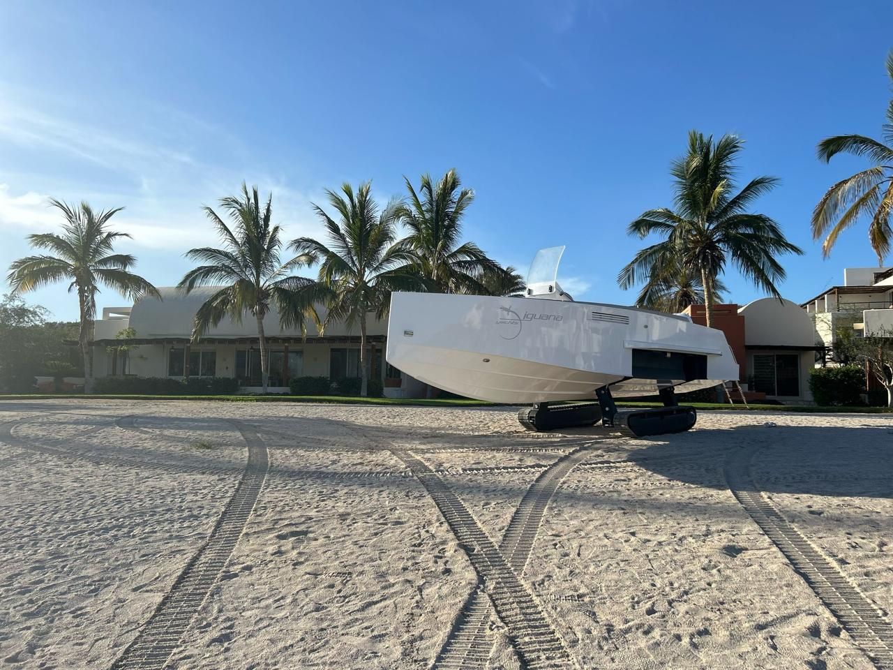 Iguana Original Amphibious Iguana boat on sandy beach with palm trees, 2023 model.