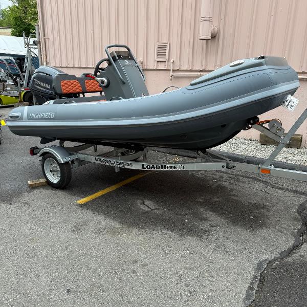 Highfield Sport 360 2024 Highfield Sport 360 boat on Load Rite trailer, parked outdoors.