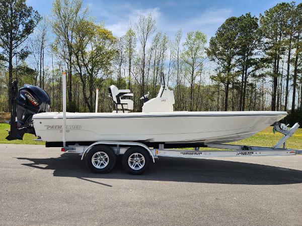 Pathfinder 2300 HPS 2025 Pathfinder 2300 HPS boat on trailer, parked outdoors with trees in the background.