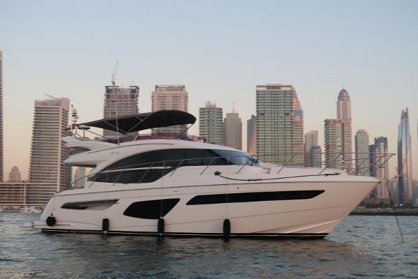 Princess F55 Luxury Princess F55 yacht cruising near city skyline at sunset, 2020 model.