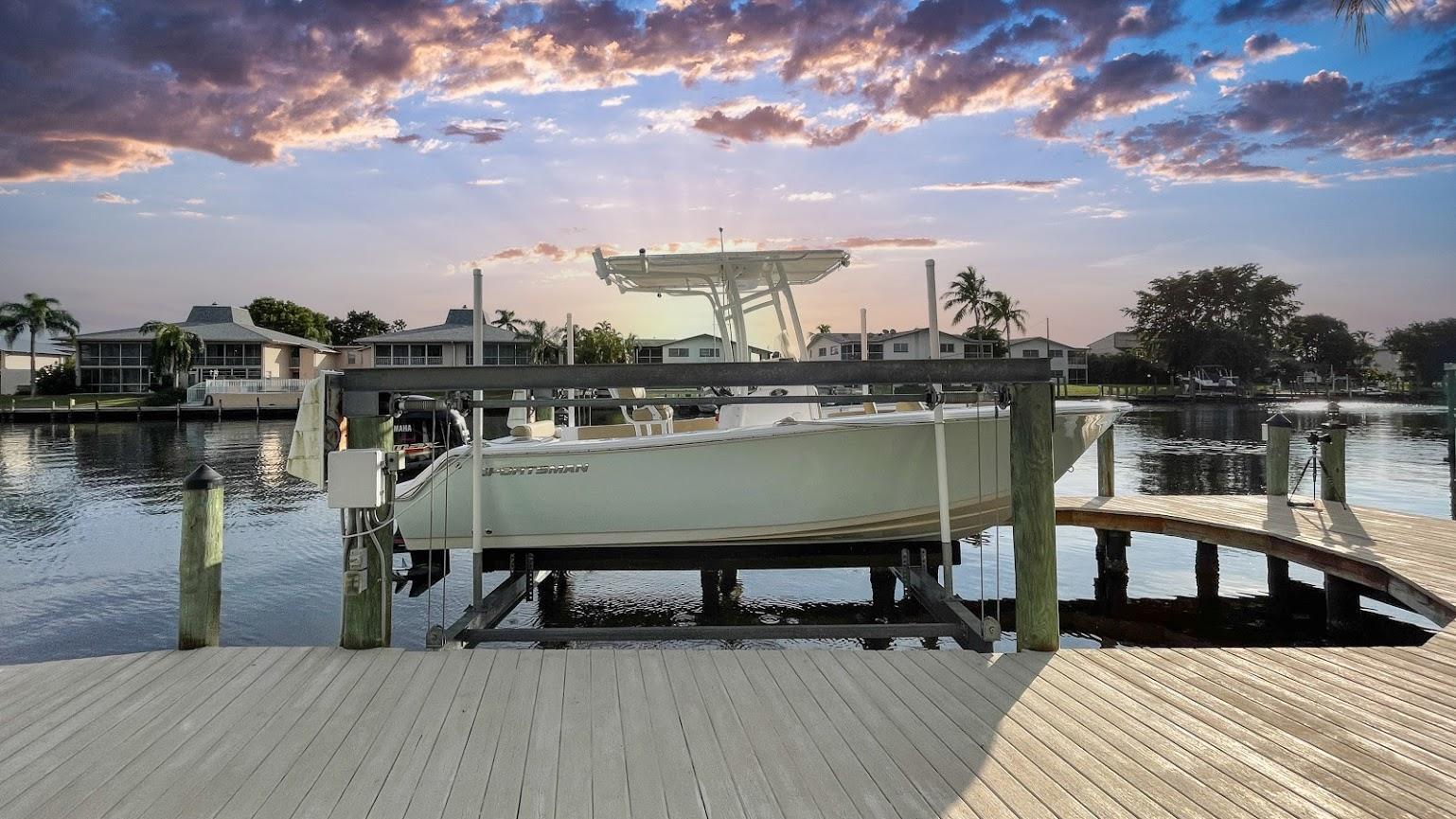 Sportsman Open 212 2018 Sportsman Open 212 boat docked at a scenic waterfront during sunset.