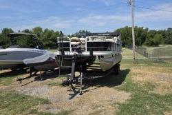 Sun Tracker Bass Buggy 18 DLX 2021 Sun Tracker Bass Buggy 18 DLX pontoon boat on trailer, parked outdoors.