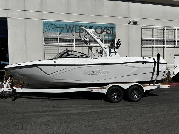 Malibu Wakesetter 23 LSV 2025 Malibu Wakesetter 23 LSV boat on trailer outside West Coast dealership.