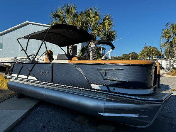 Crest Caribbean LX 230 2024 Crest Caribbean LX 230 pontoon boat with black canopy and palm trees in the background.