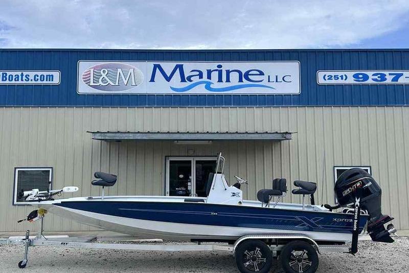 Xpress H22 2026 Xpress H22 boat on trailer outside L&M Marine dealership.
