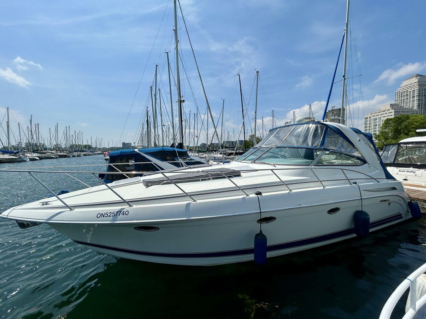 Formula 37 PC 2002 Formula 37 PC yacht docked in a marina under a clear blue sky.