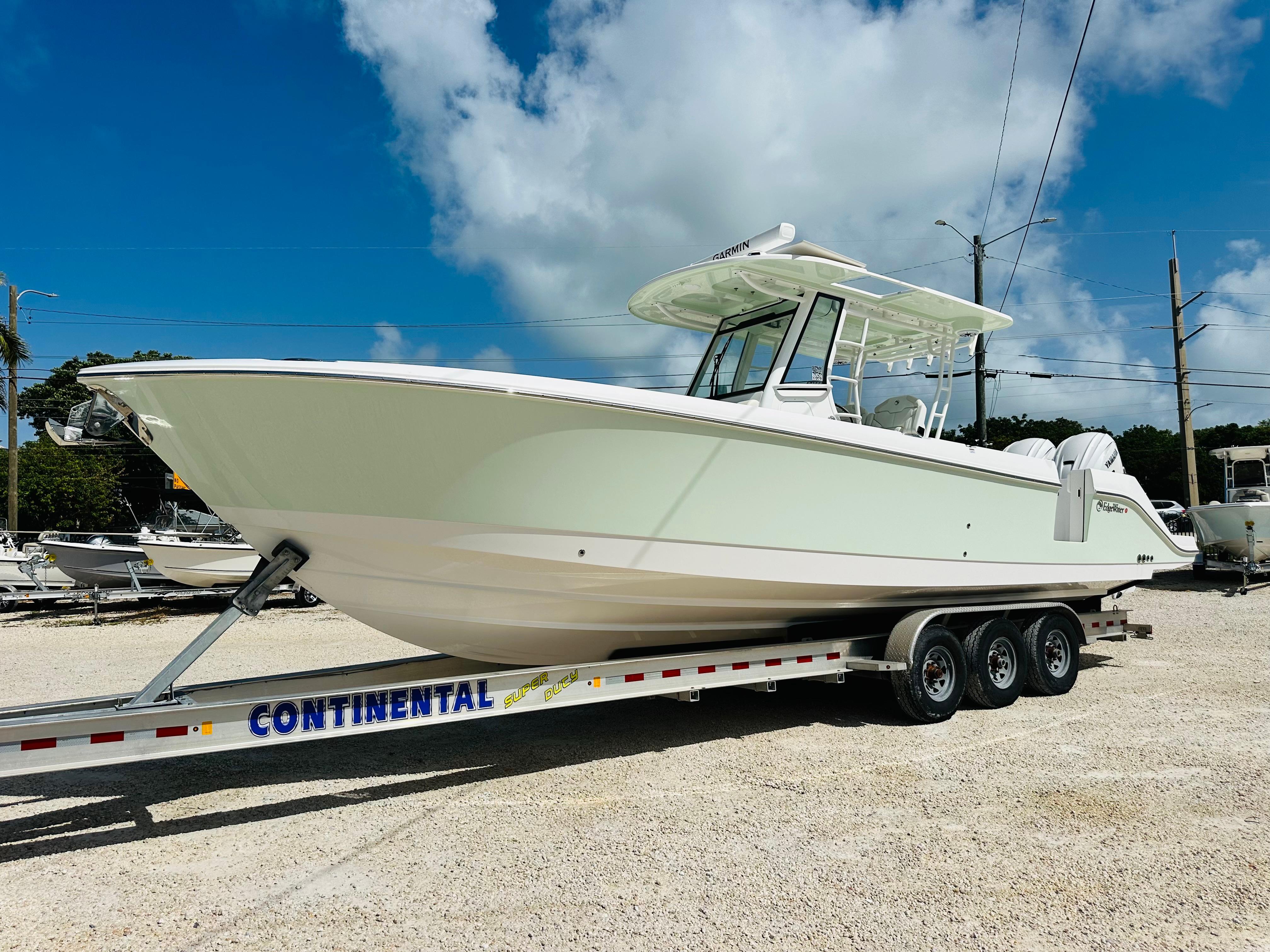 Edgewater 340CC 2025 Edgewater 340CC boat on a Continental trailer under a clear blue sky.