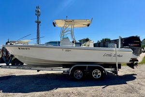 Everglades 223 Center Console 2004 Everglades 223 Center Console boat on trailer, named "Little Sister," under clear blue sky.