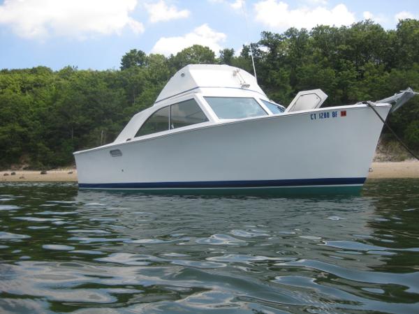 Alglas 25 1969 Alglas 25 boat on calm water near a wooded shoreline.