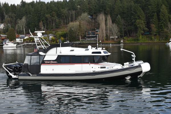 SAFE Boats 33 2005 SAFE Boats 33 on calm water, surrounded by forested shoreline.