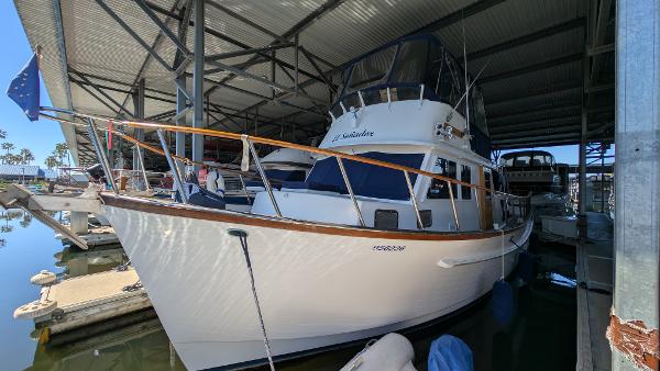 Monk 36 1982 Monk 36 yacht docked in a marina under a metal canopy.