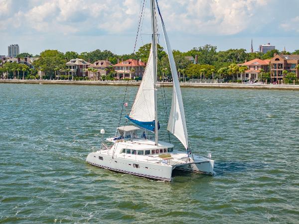 Lagoon 500 Lagoon 500 catamaran sailing near a coastal town, 2006 model.