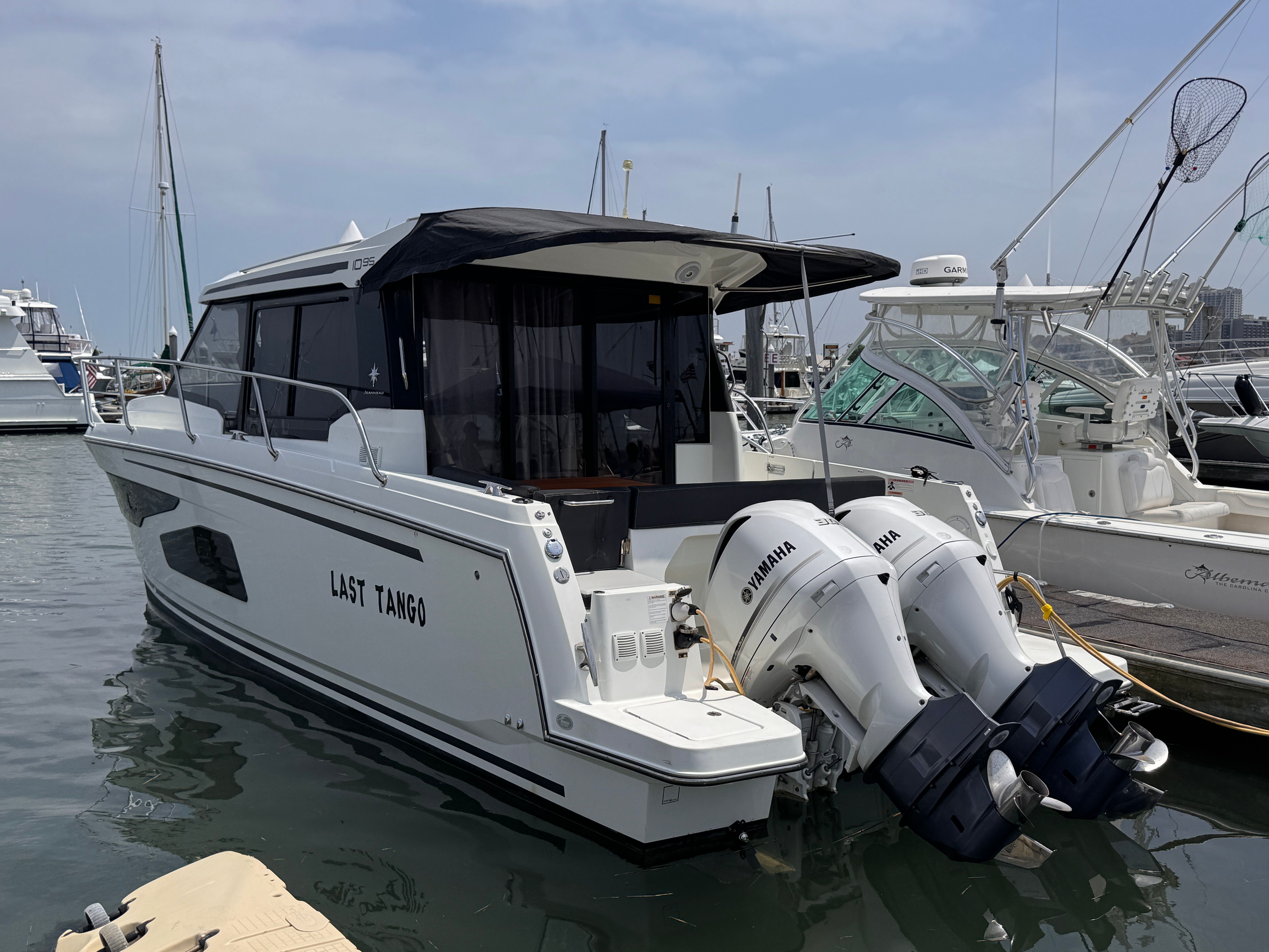 Jeanneau NC 1095 2020 Jeanneau NC 1095 boat named "Last Tango" docked with twin Yamaha engines.