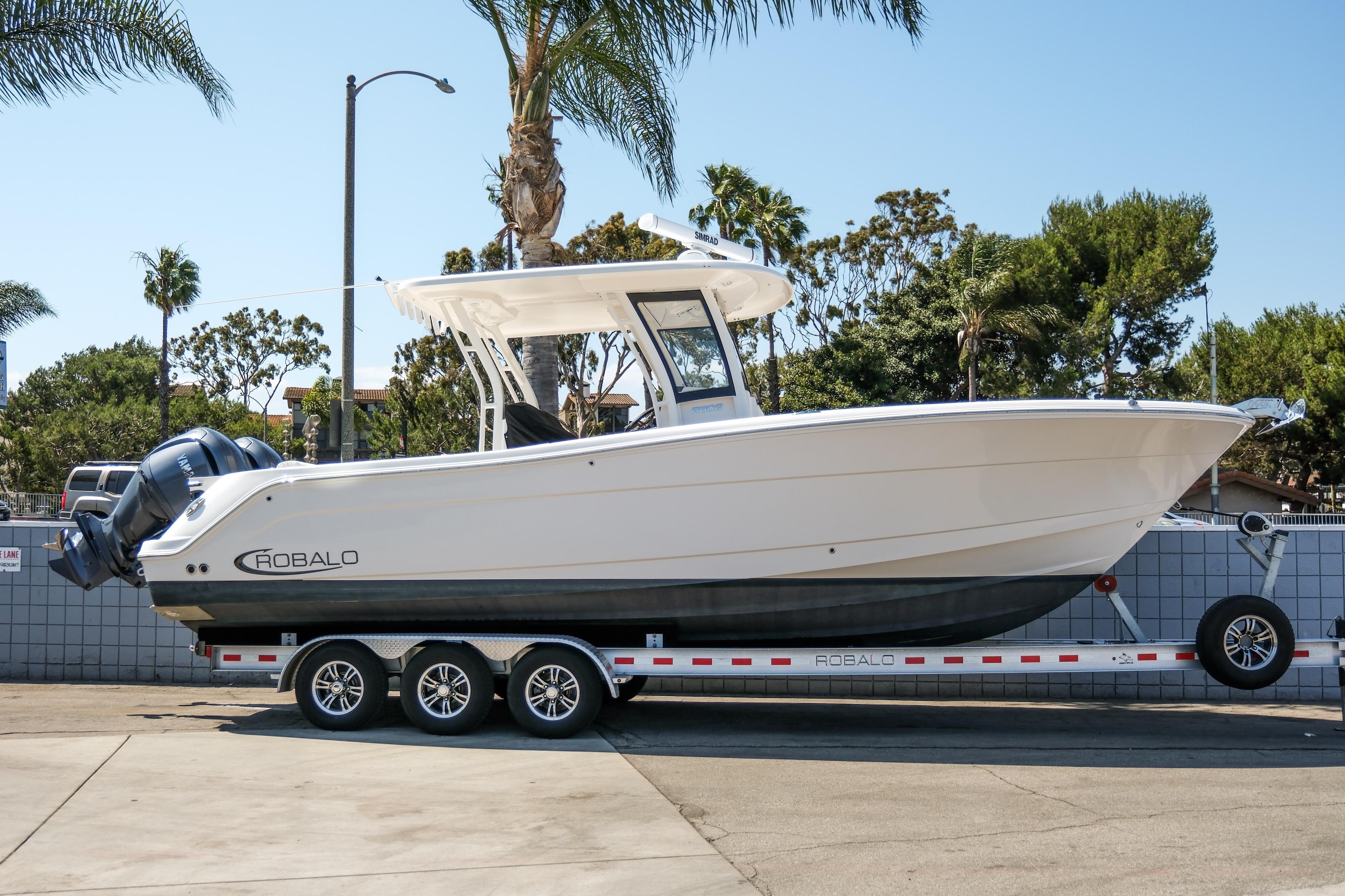 Robalo R302 Center Console 2023 Robalo R302 Center Console boat on trailer, parked outdoors.