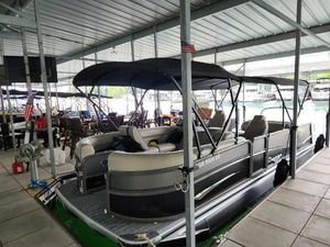 Premier 250 Solaris RL 2023 Premier 250 Solaris RL pontoon boat docked under a covered marina.