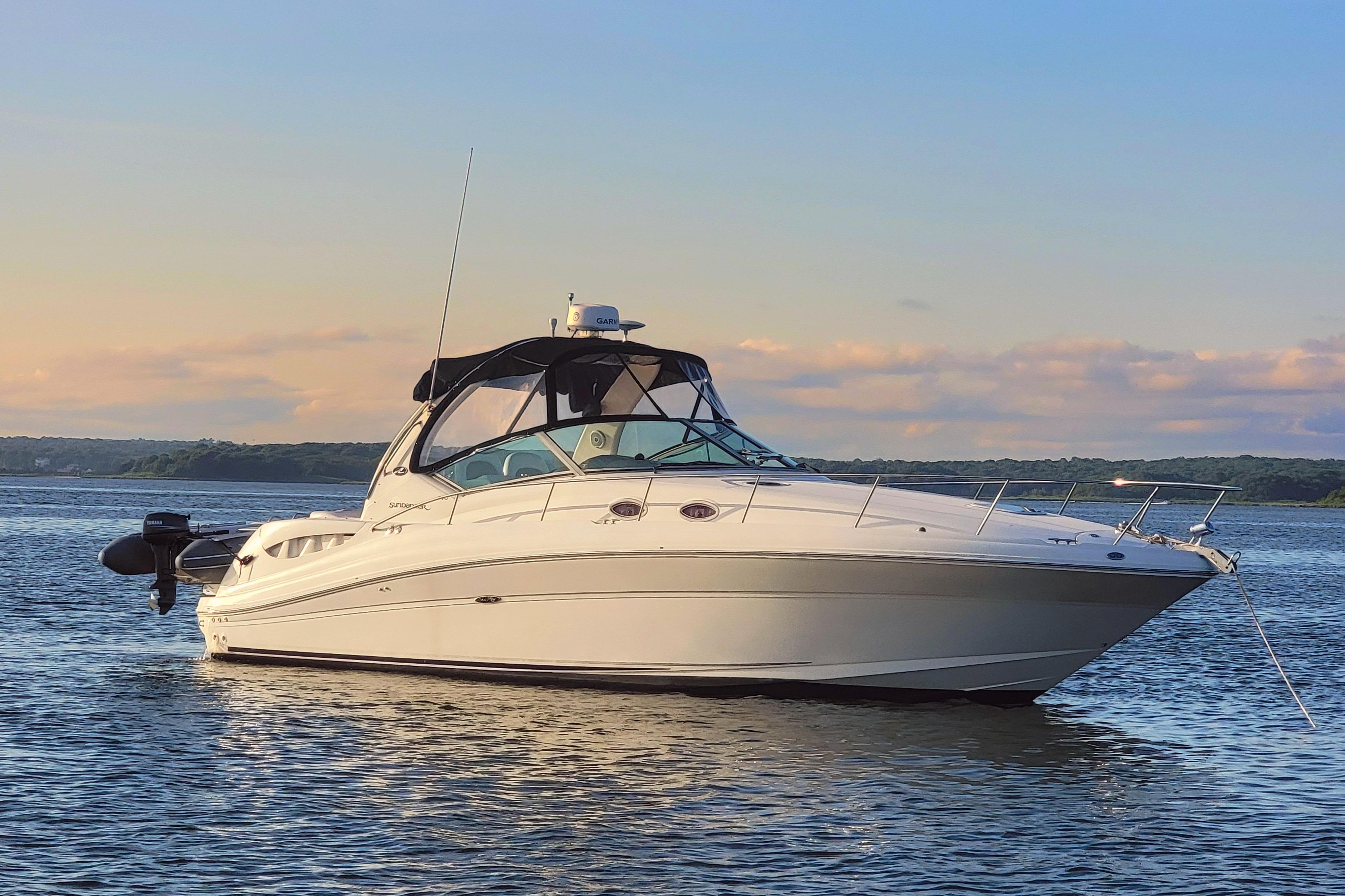 Sea Ray 340 Sundancer 2004 Sea Ray 340 Sundancer yacht on calm water at sunset.