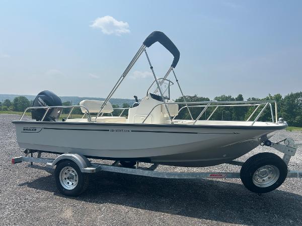 Boston Whaler 150 Montauk 2025 Boston Whaler 150 Montauk boat on trailer, parked outdoors under clear sky.