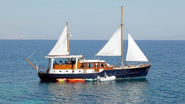 Custom Akerboom, Lisse Vintage 1958 Akerboom sailboat with dual masts on calm blue sea.