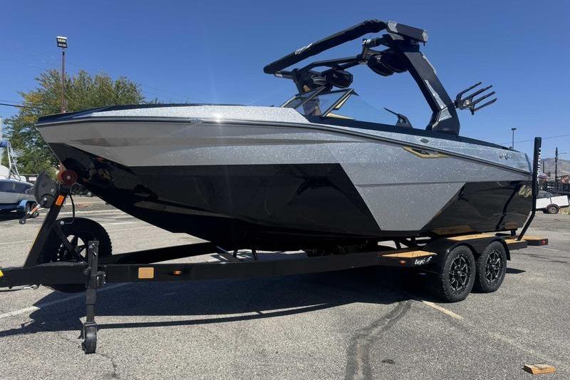 Tigé Z3 2026 Tigé Z3 boat on trailer, sleek design, parked outdoors under clear sky.