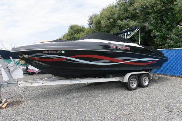 Rinker Captiva 246 BR 2013 Rinker Captiva 246 BR boat on a trailer, black with red and blue accents.