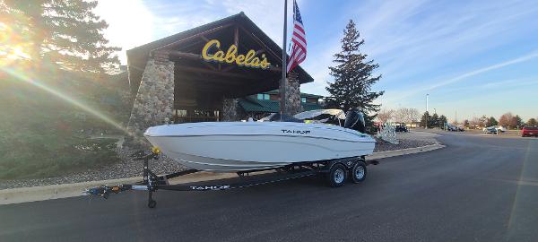 Tahoe T21 2024 Tahoe T21 boat on trailer outside Cabela's store with American flag.